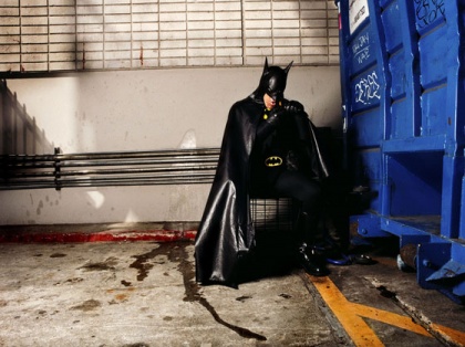 man dressed as batman sitting in the street in LA